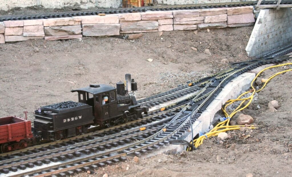 A steam engine runs smooth on track supported by concrete blocks
