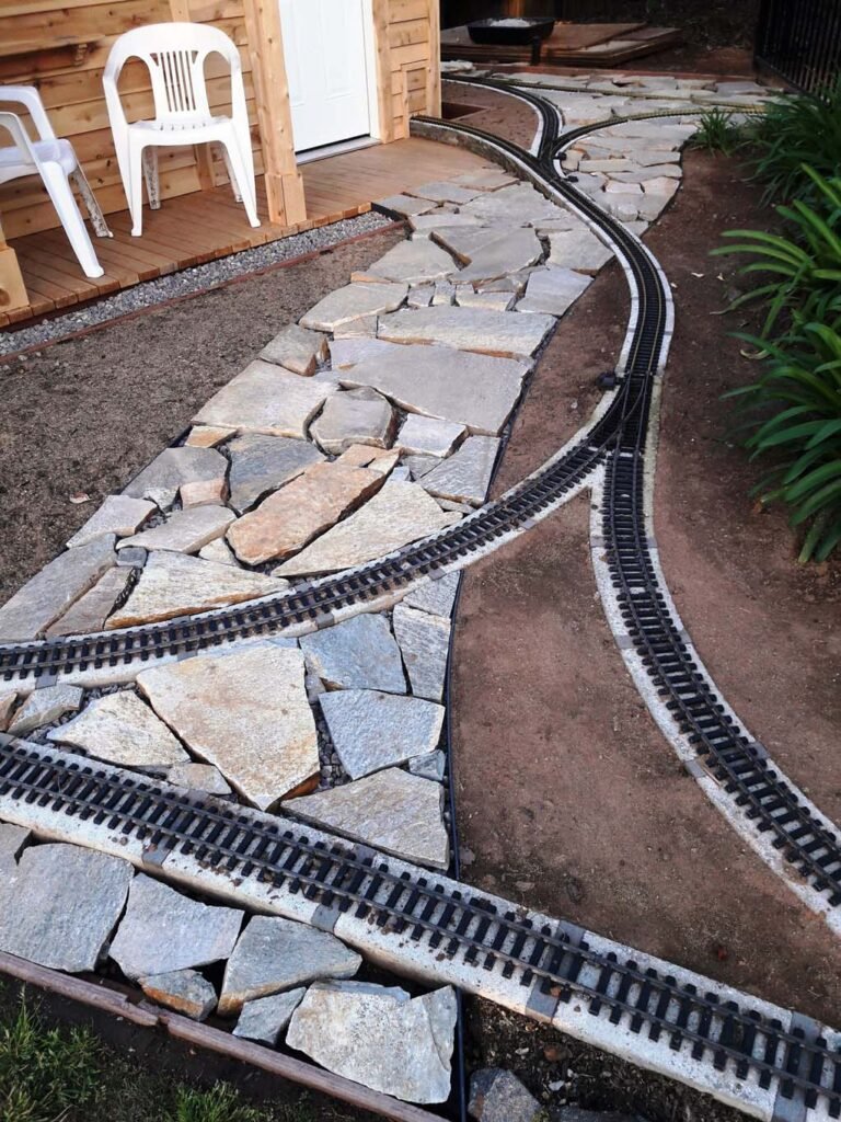 Track and flagstone walk goes in